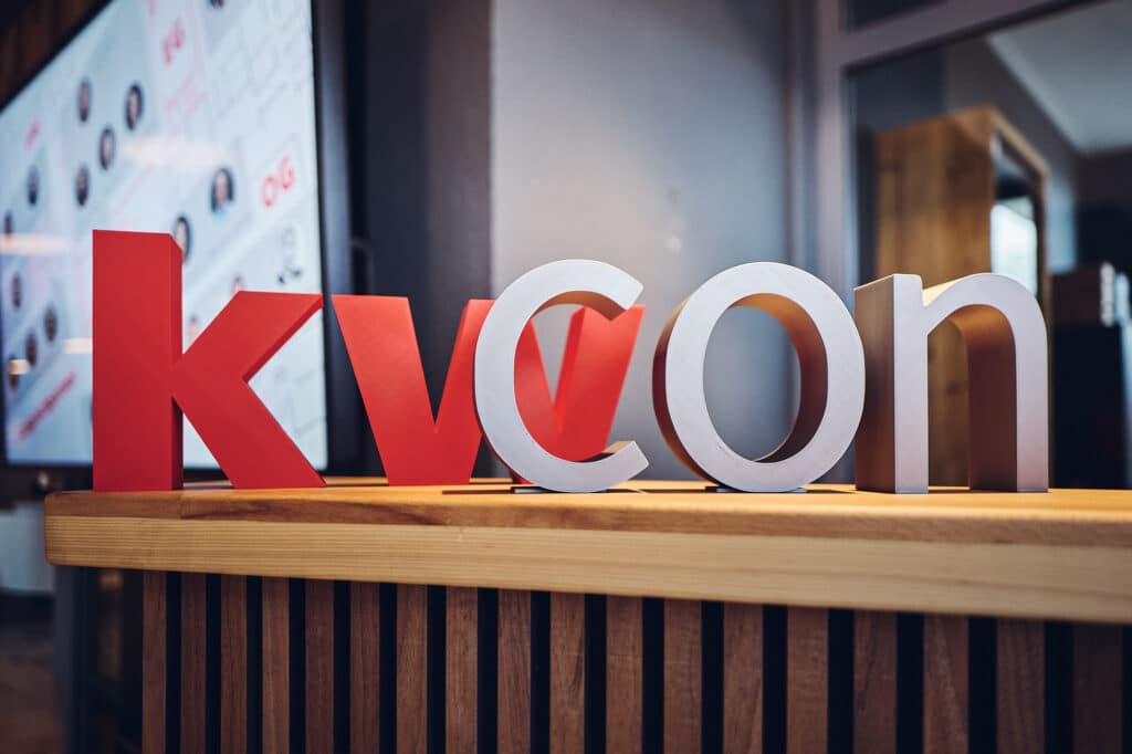 Letters on the table spell out the word kwcon.