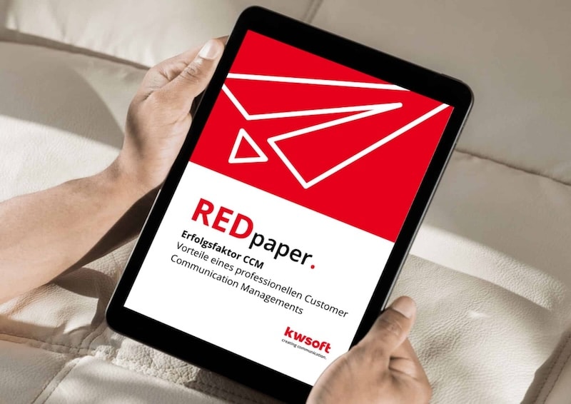 A person is holding a tablet in their hand with a RedPaper from kwsoft open on it.